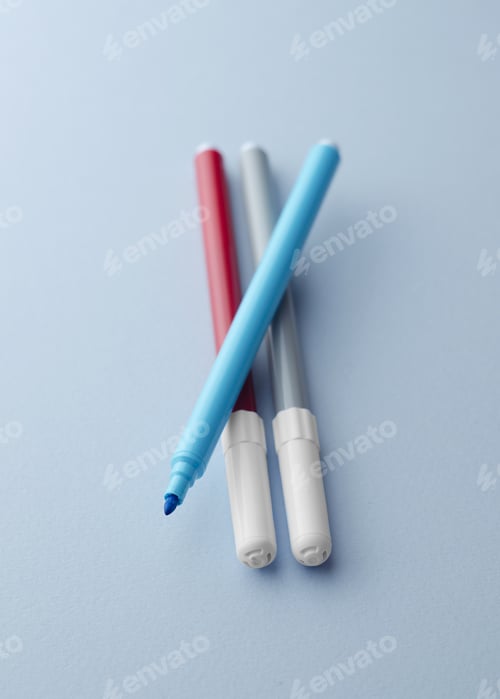 Preview: Close Up Of Colorful Magic Markers Over Blue Background