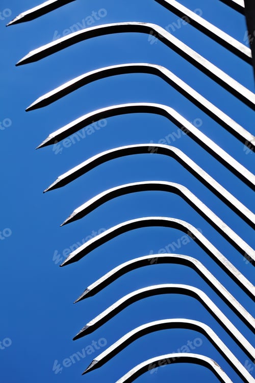 Preview: Sharp Metal Fence Pikes Against Blue Sky