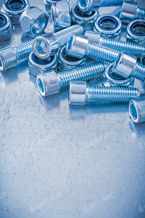Preview: Group Of Threaded Construction Nuts And Screw Bolts On Metallic Background Copy Space Image