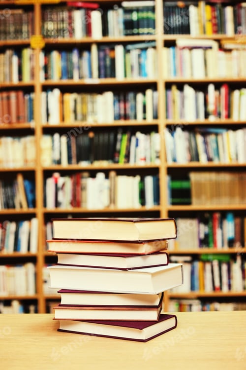 Preview: Stacked Books On A Desk In The Library