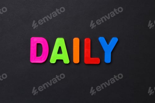 Preview: The Word Daily Written In Letters Of The Children'S Magnetic Alphabet On A Black Background