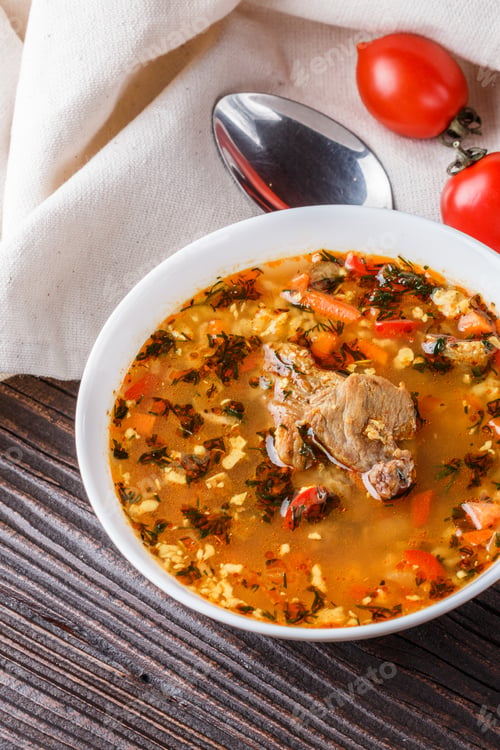 Preview: Georgian Soup. Kharcho With Rice, Tomato, Beef, Garlic And Herbs In Bowl On Wooden Table