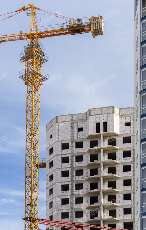 Preview: Building Crane And Building Under Construction Against Blue Sky