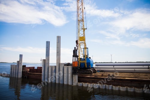 Preview: Piling Machine Working On The River Bank Hammers Piles To Strengthen The Bank And Build A Bridge