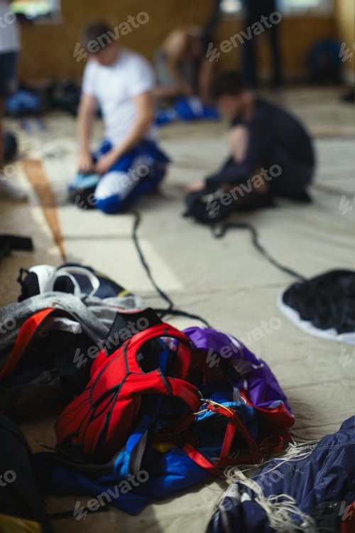 Preview: Details Of Parachute Equipment On The Background Of Skydivers Packing Parachutes Before Jumping.