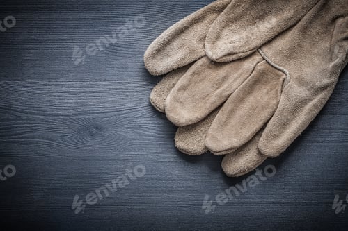 Preview: Leather Working Gloves On Dark Board.