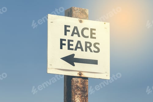Preview: Face Fears, Word And Arrow Signpost On Clear Sky Background. Motivational Sign. Vintage Style.