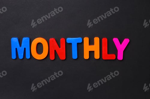 Preview: The Word Monthly Written In Letters Of The Children'S Magnetic Alphabet On A Black Background