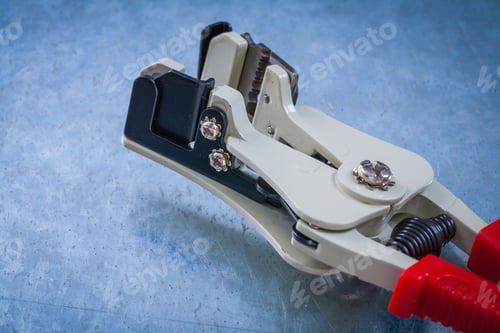 Preview: Automatic Wire Strippers On Scratched Metallic Background Top View Image.