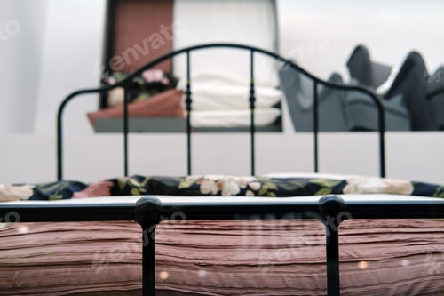 Preview: Fitted Metal Bed With A Blanket And Pillows On A Shop Window.