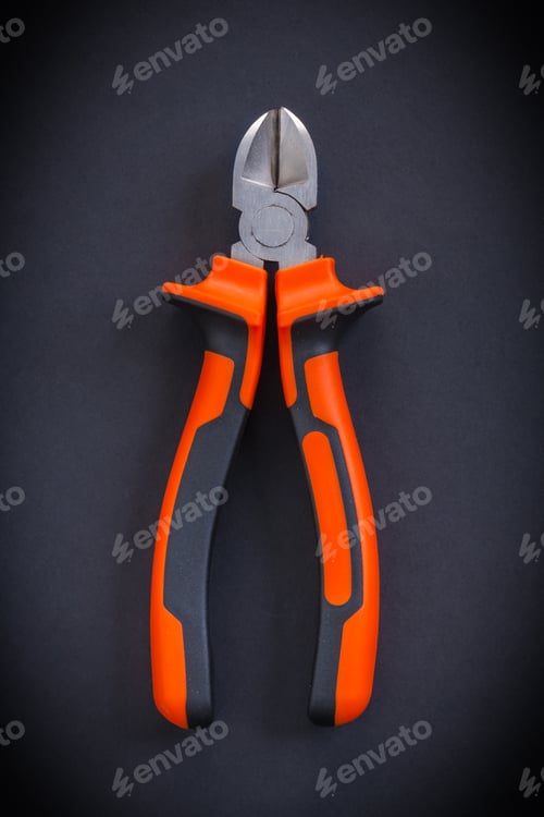 Preview: Nippers With Orange Handles Aerial View On Black Background