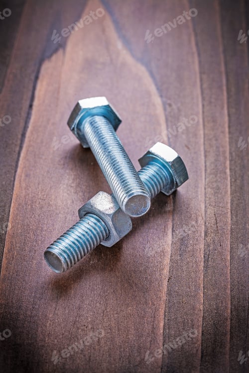 Preview: Bolts And Nut On Vintage Wooden Board Construction Concept