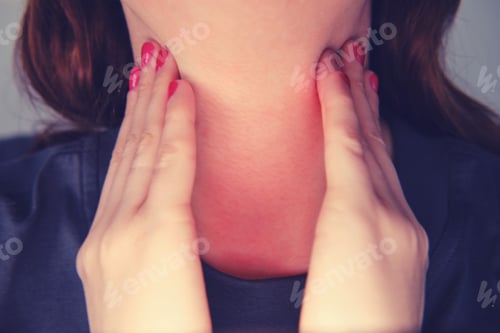 Preview: Redhead Woman Holds Her Red Sore Throat With Both Hands, Close-Up