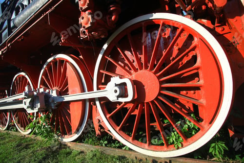 Preview: Color Image Of An Abandoned Steam Locomotive'S Wheels, With Plants Growing Around Them.
