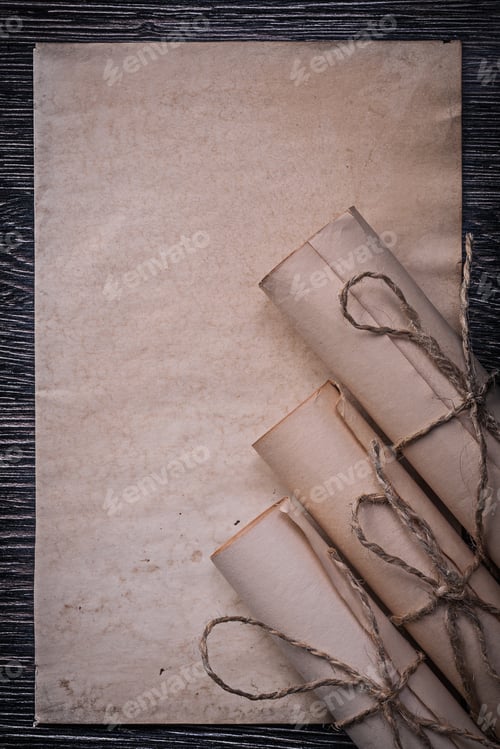 Preview: Heap Of Vintage Rolled Medieval Paper On Wooden Background.