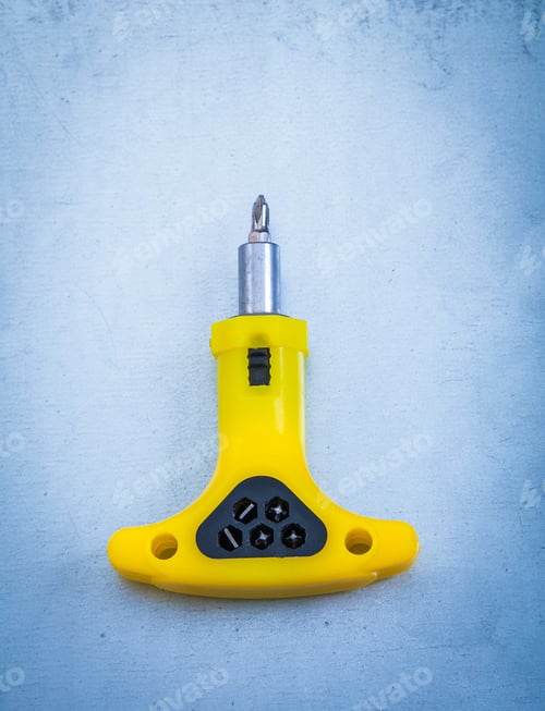 Preview: Insulated Electric Screwdriver On Metallic Background Construction Concept.