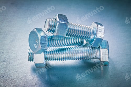 Preview: Threaded Screw Nuts And Metal Bolts On Metallic Background Construction Concept