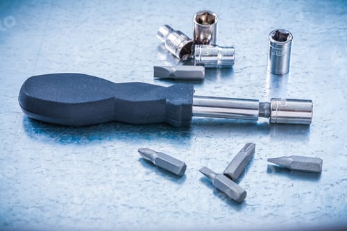 Preview: Metallic Background With Reversible Screwdriver And Set Of Steel Screw Bits And Torxes Construction