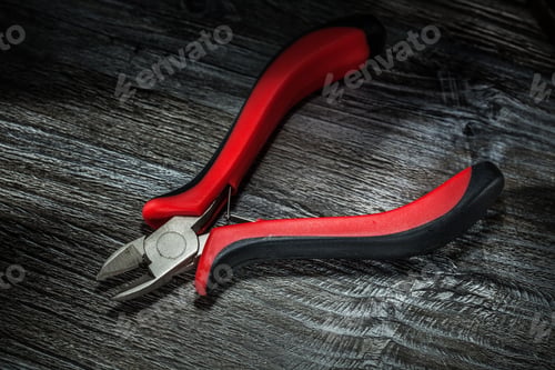 Preview: Sharp Cutting Pliers On Wooden Board.