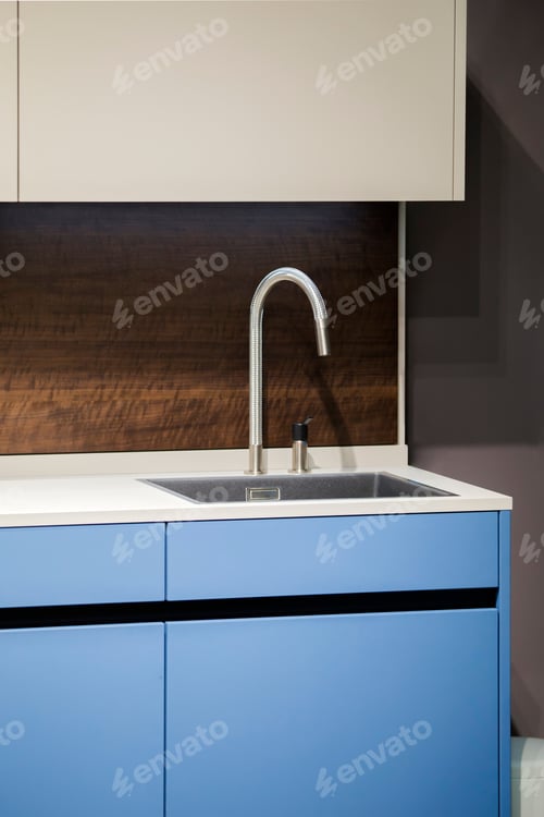 Preview: Beautiful Blue Kitchen Unit, Kitchen Faucet, Wooden Apron In The Kitchen. Modern Minimalistic