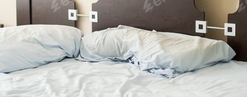 Preview: Empty Bed With Disheveled Pillows And Sheets