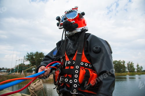 Preview: Diver In The Water In A Diving Suit And Helmet Ready To Dive