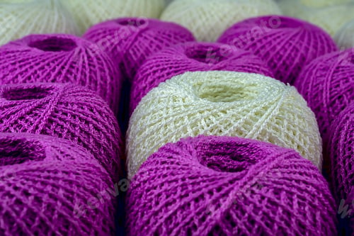 Preview: One White Ball Of Yarn Among Purple Balls
