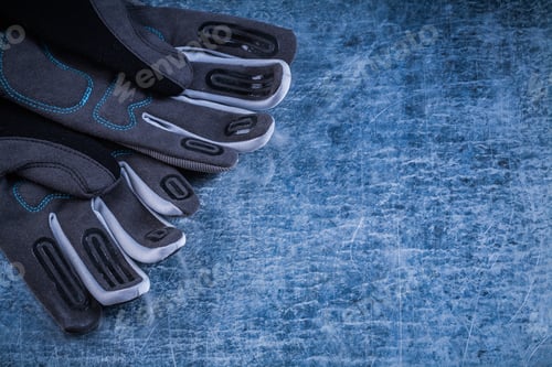 Preview: Staff Protective Gloves On Scratched Metallic Background Copy Space.