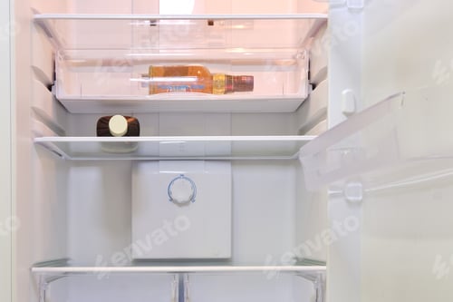 Preview: Two Full Bottles Of Whiskey. Alcohol Bottles In Empty Refrigerator