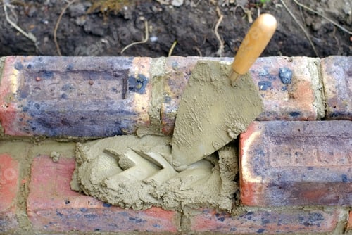 Preview: Bricklayers Trowel And Mortar On A Construction Site