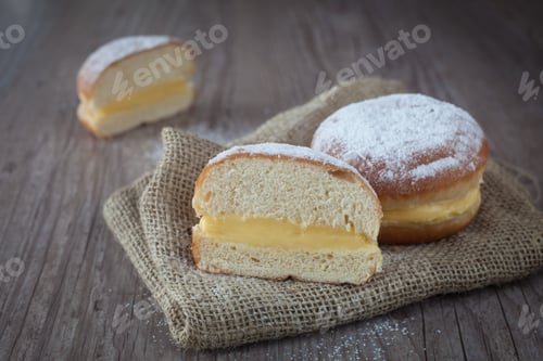 Preview: Delicious Krapfen With Cream On A Wooden Background