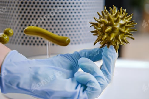 Preview: Hand In A Medical Glove Holds Caronavirus For Research In The Laboratory, Concept. Search For A Flu