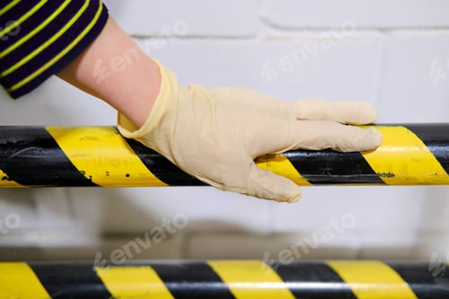 Preview: Hand In Medical Gloves On The Background Of A Restrictive Barrier, Concept. Quarantine And