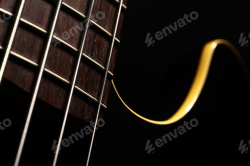 Preview: Detail Of The Fret Board Of A Bass Guitar, On A Dark Background.