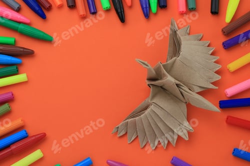 Preview: Origami Paper Bird Mockup. Selective Focus. A Lot Of Multi-Colored Felt-Tip Pens On A Blurry