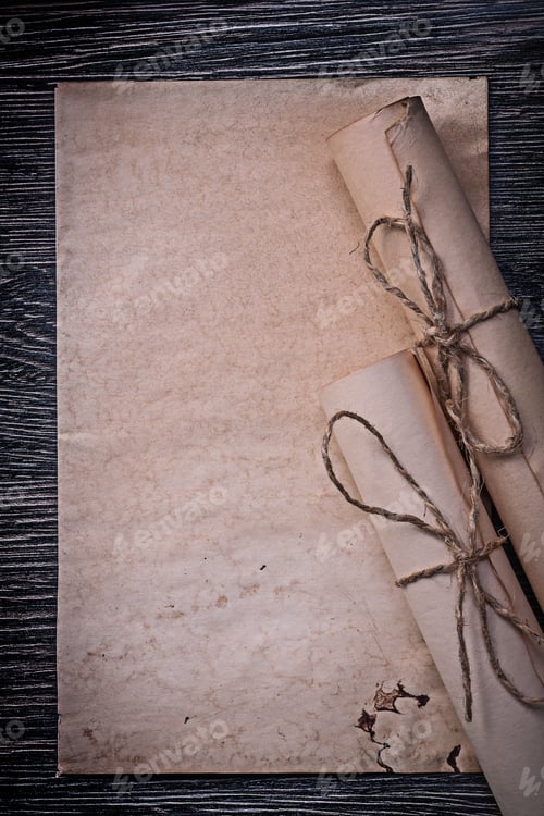 Preview: Heap Of Vintage Rolled Medieval Paper On Wooden Board.