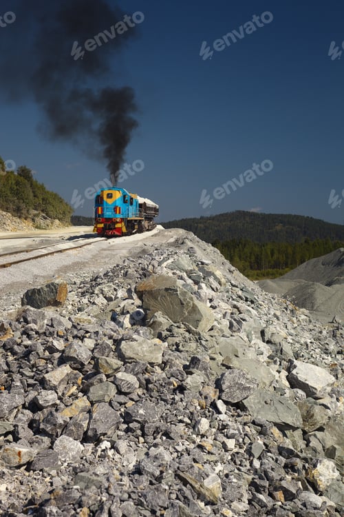 Preview: Diesel Locomotive Emitting A Column Of Black Smoke In A Quarry For Limestone Mining, With Fragments