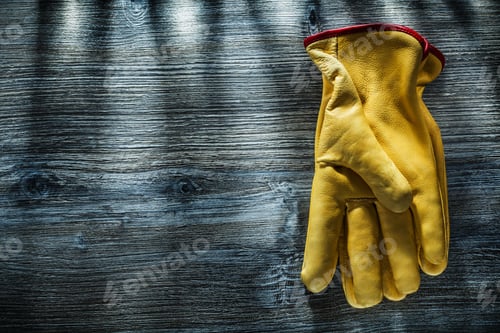 Preview: Leather Protective Gloves On Vintage Wooden Board.