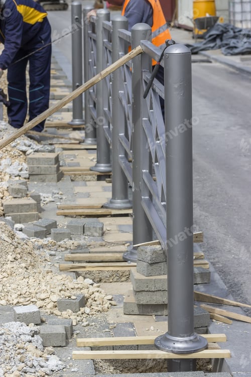 Preview: Workers Install Street Protective Fence, Fence Installation. Selective Focus And Shallow Dof.