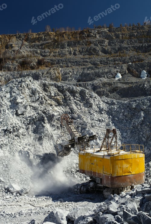 Preview: Yellow Quarry Excavator At The Bottom Of A Deep Stone Quarry On A Sunny Day On A Background Of The