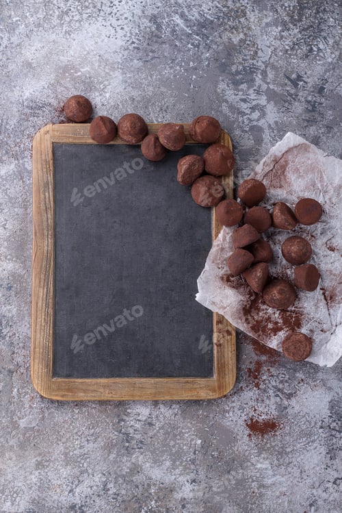 Preview: Home Made Chocolate Truffles On The Paper And Chalk Board Decorated With Cinnamon, Star Anise And