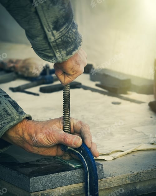 Preview: The Worker Attaches To The Table A Piece Of Granite For Grinding.