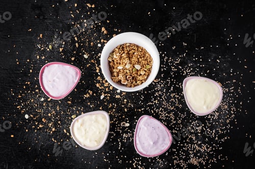 Preview: Granola Oats And Grains Breakfast With Yogurt Over Black Wooden Background. Top View