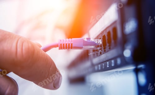 Preview: Technician Connecting Network Cables To Switches. Connecting Cables In Server Cabinet. Background
