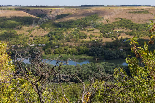 Preview: View Of The River From A Huge Hill Or Mountain. Green Forest Nature Background. Selective Focus.
