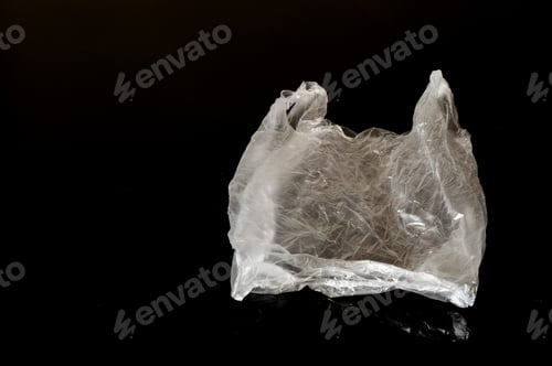 Preview: White Plastic Bag Isolated On Dark Background