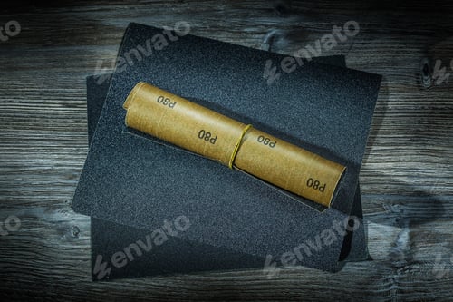 Preview: Roll Of Sandpaper And Sheets Of It On Vintage Wood