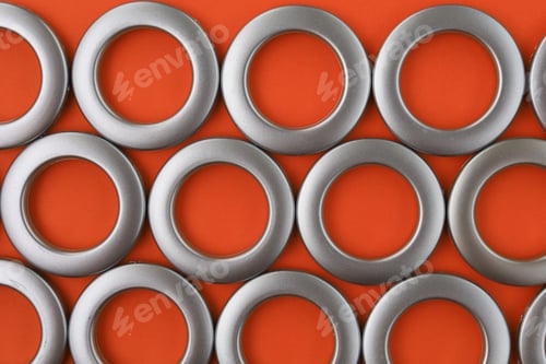 Preview: Classic Chrome Eyelets For Curtains On An Orange Background.