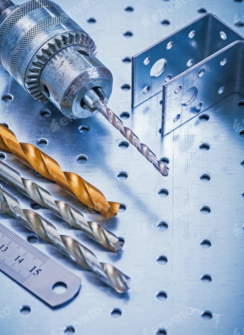 Preview: Perforated Angle Fasteners Metal Ruler Drill And Bits On Metallic Background Construction Concept.