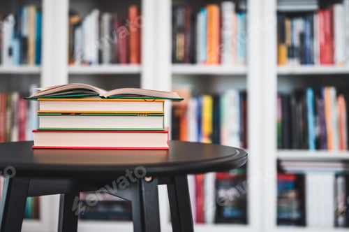 Preview: A Stack Of Books On A Black Table. Library In The Background. Stack Of Books Close Up.